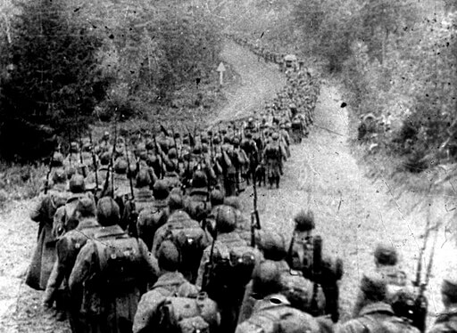 black and white photo of groups of soldiers marching in a long line facing away from camera- how many times has poland been invaded